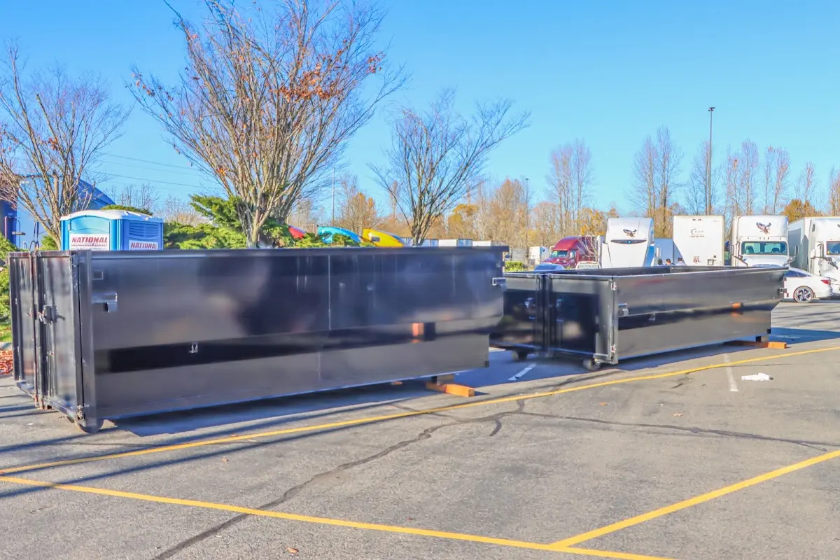 Professional dumpster rental service with roll-off container on residential driveway in Woodbury